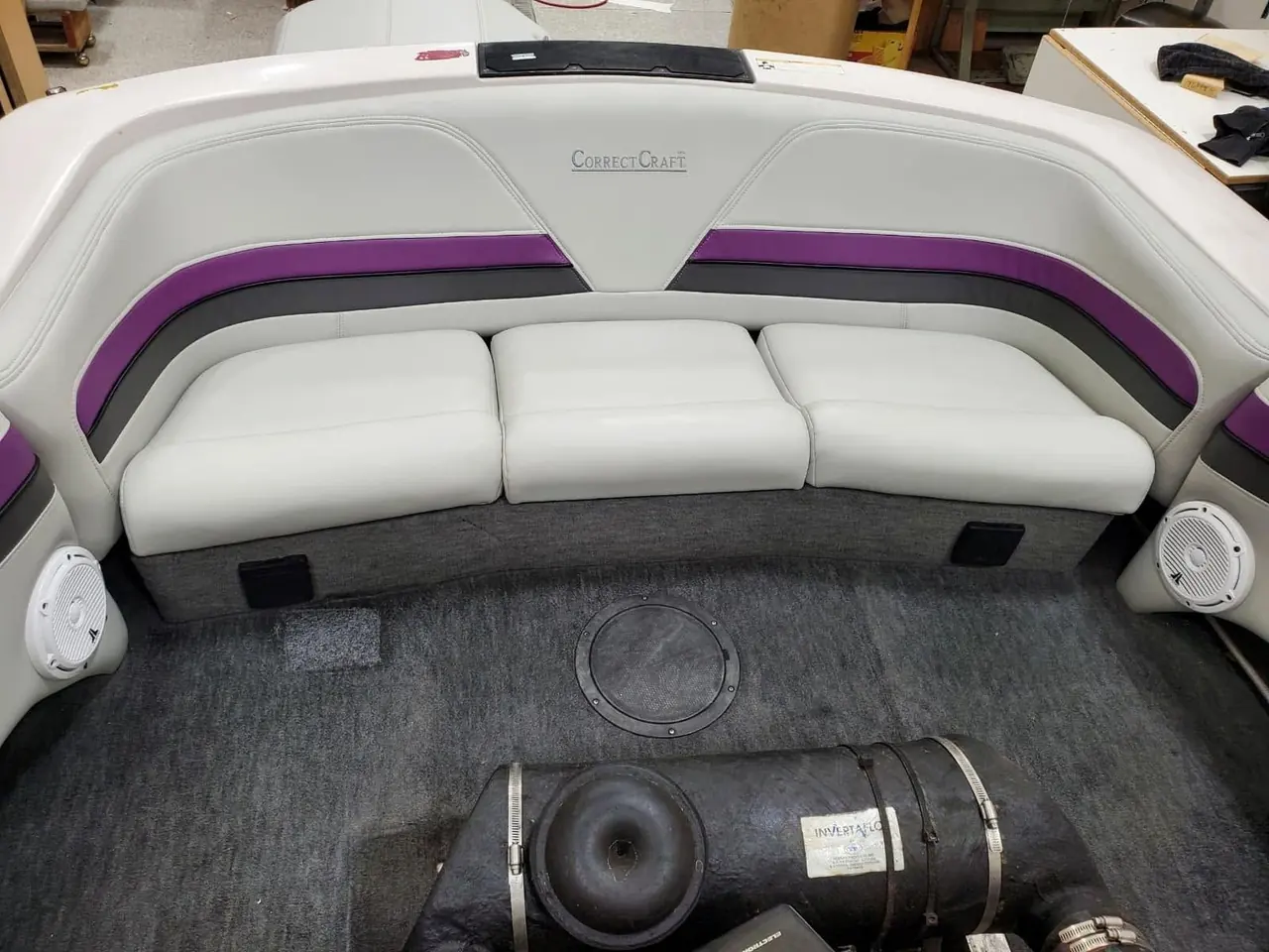 Boat interior with white and purple racing-stripe marine vinyl upholstery.