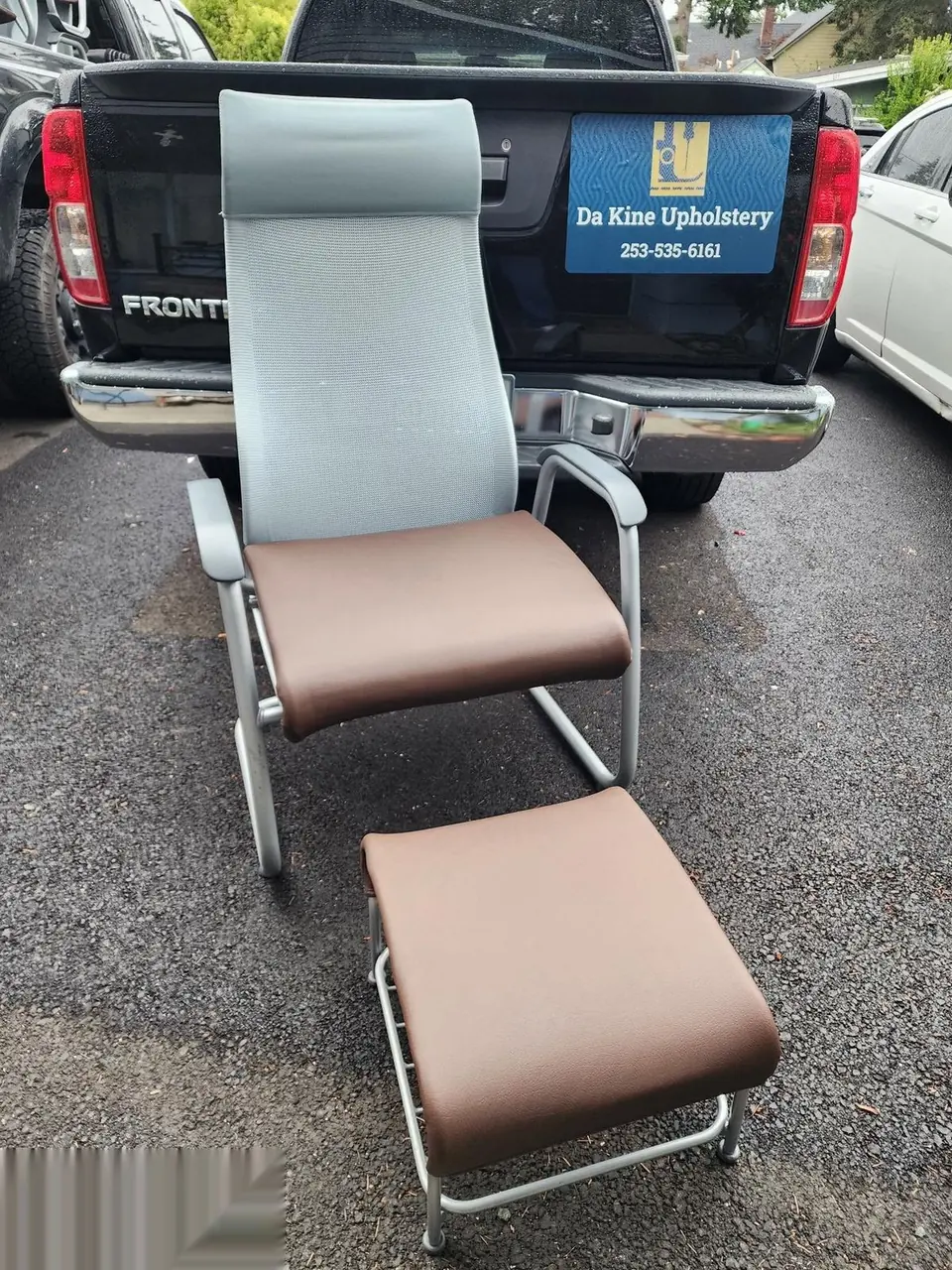 Lounge chair and ottoman reupholstered in blue and tan two-tone upholstery.