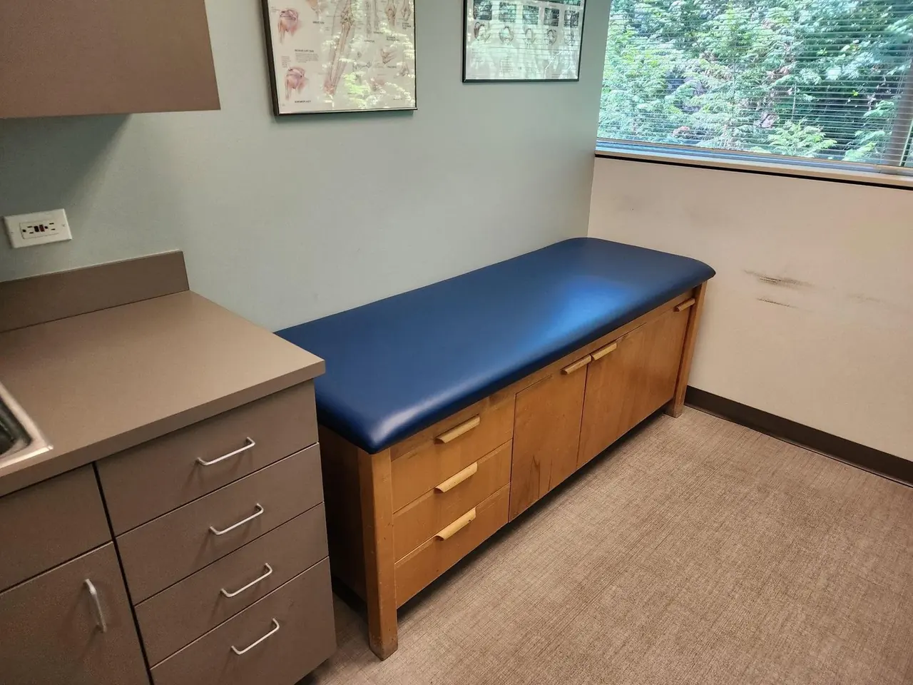Built-in bench seating reupholstered in navy vinyl for a clinic or office setting.
