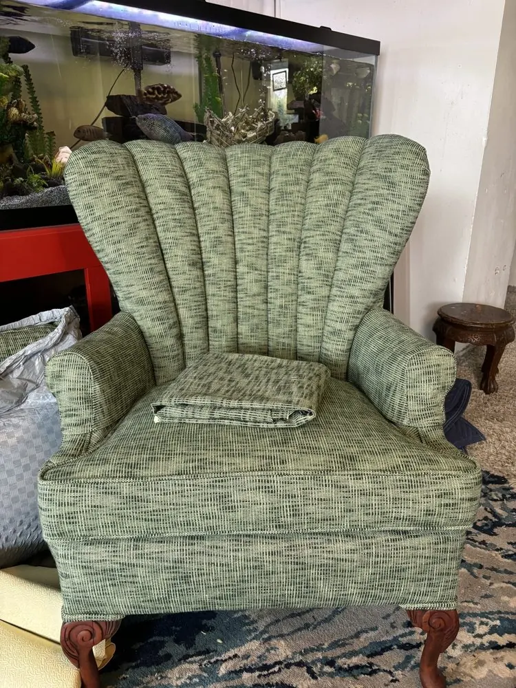 Shell-back accent chair reupholstered in green and black woven tweed fabric.