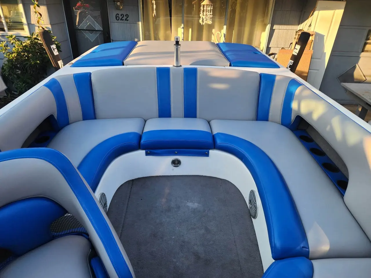 Wakeboard boat rear seating reupholstered in blue and gray marine vinyl.