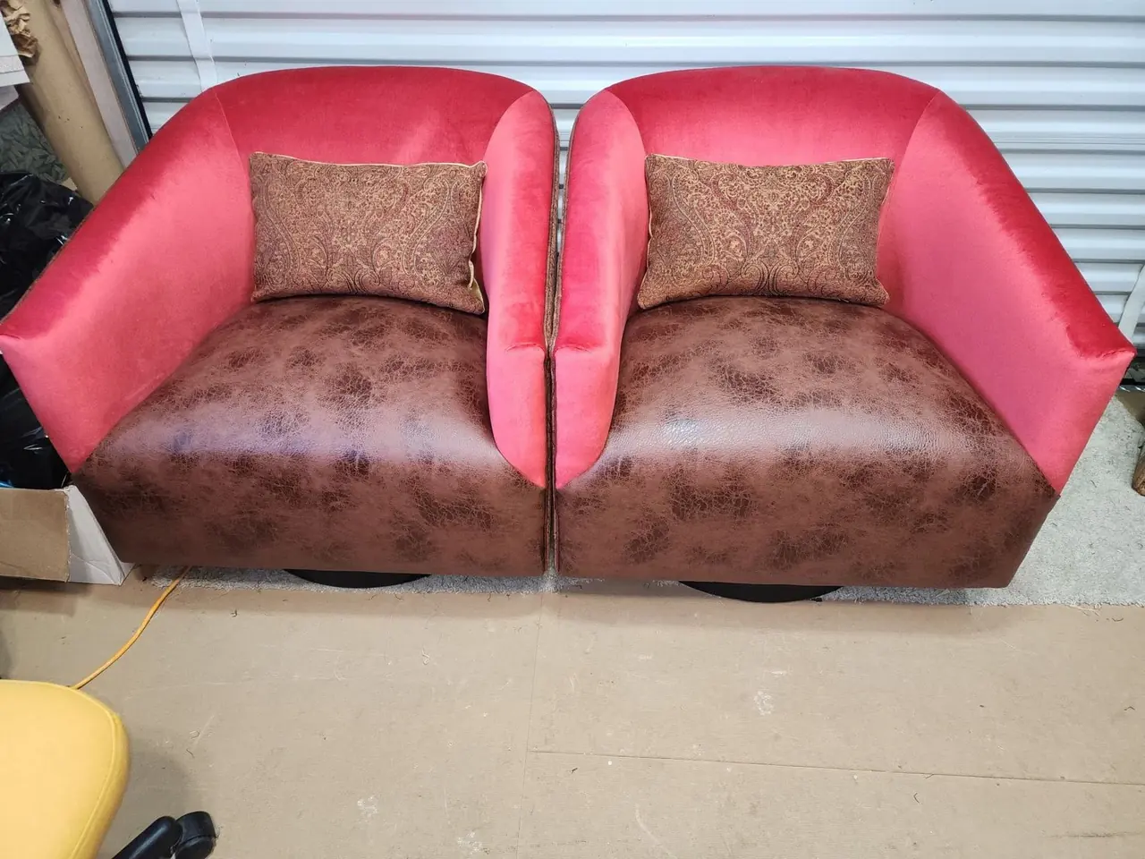 Matching pair of swivel club chairs reupholstered in a rose/mauve fabric.