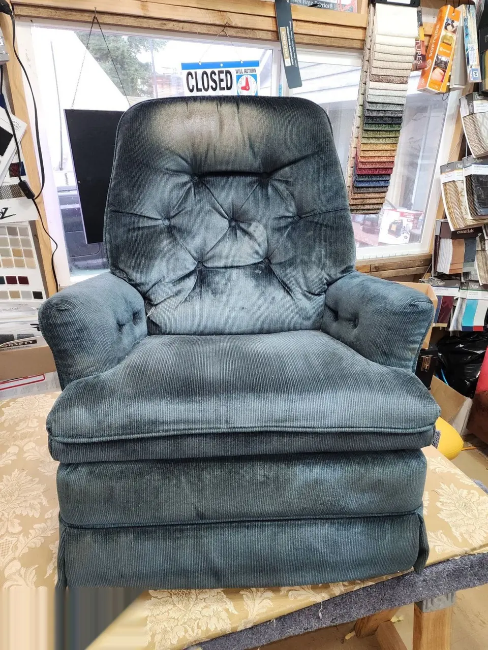 Blue-gray tufted rocker-recliner before reupholstery.