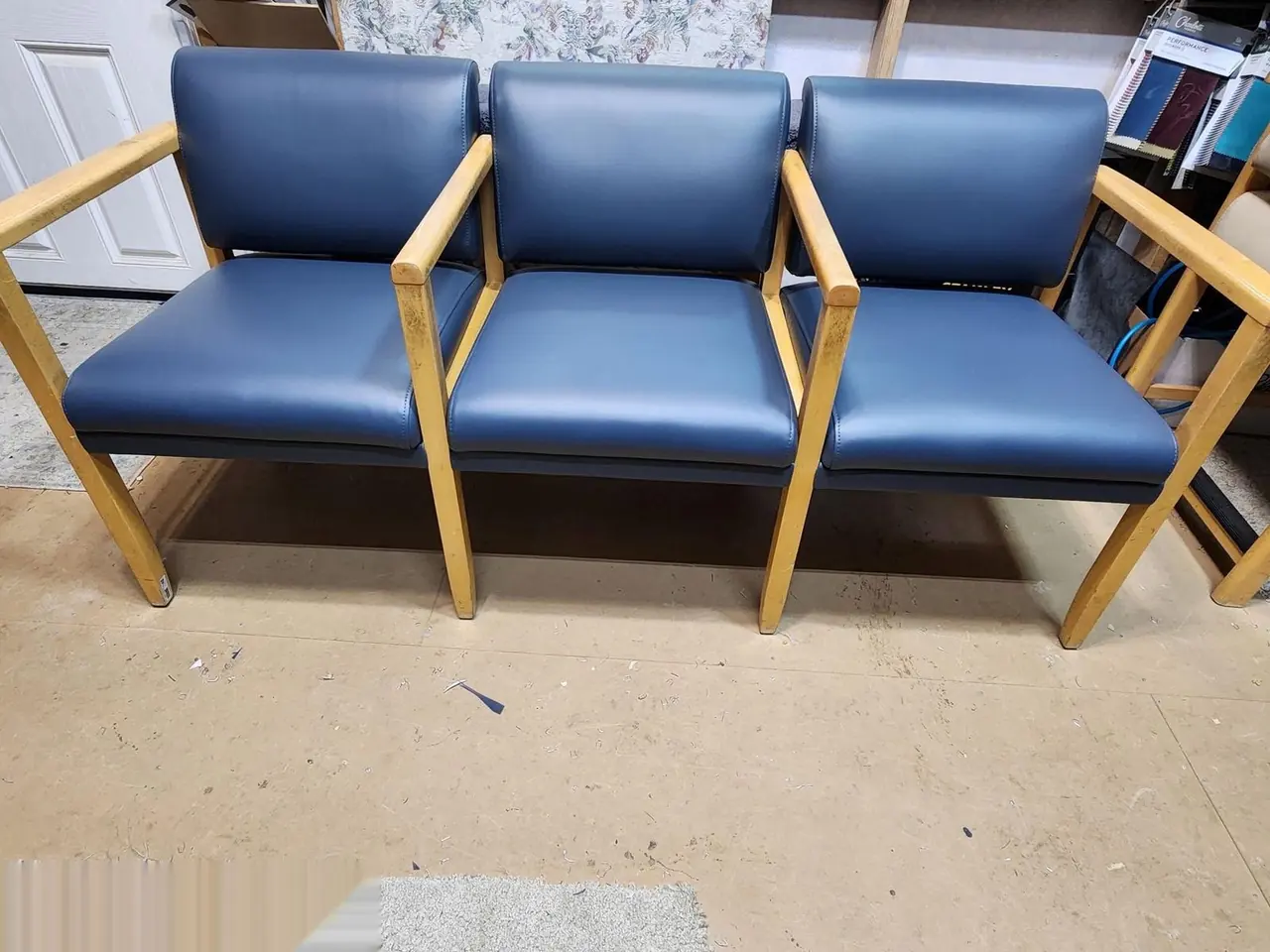 Three-seat connected bench for a medical office waiting room, navy vinyl.
