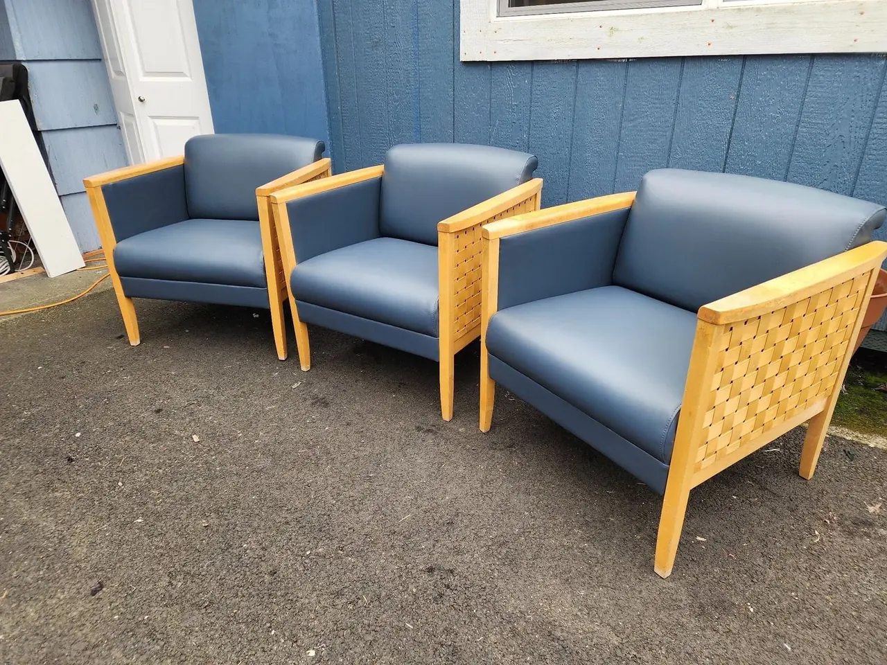 Matching set of navy vinyl club chairs for a medical office waiting room.