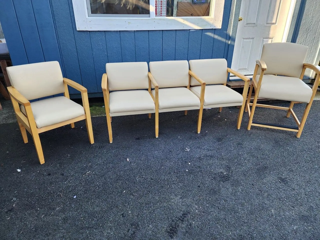 Five-piece cream vinyl waiting room chair set for a commercial lobby.