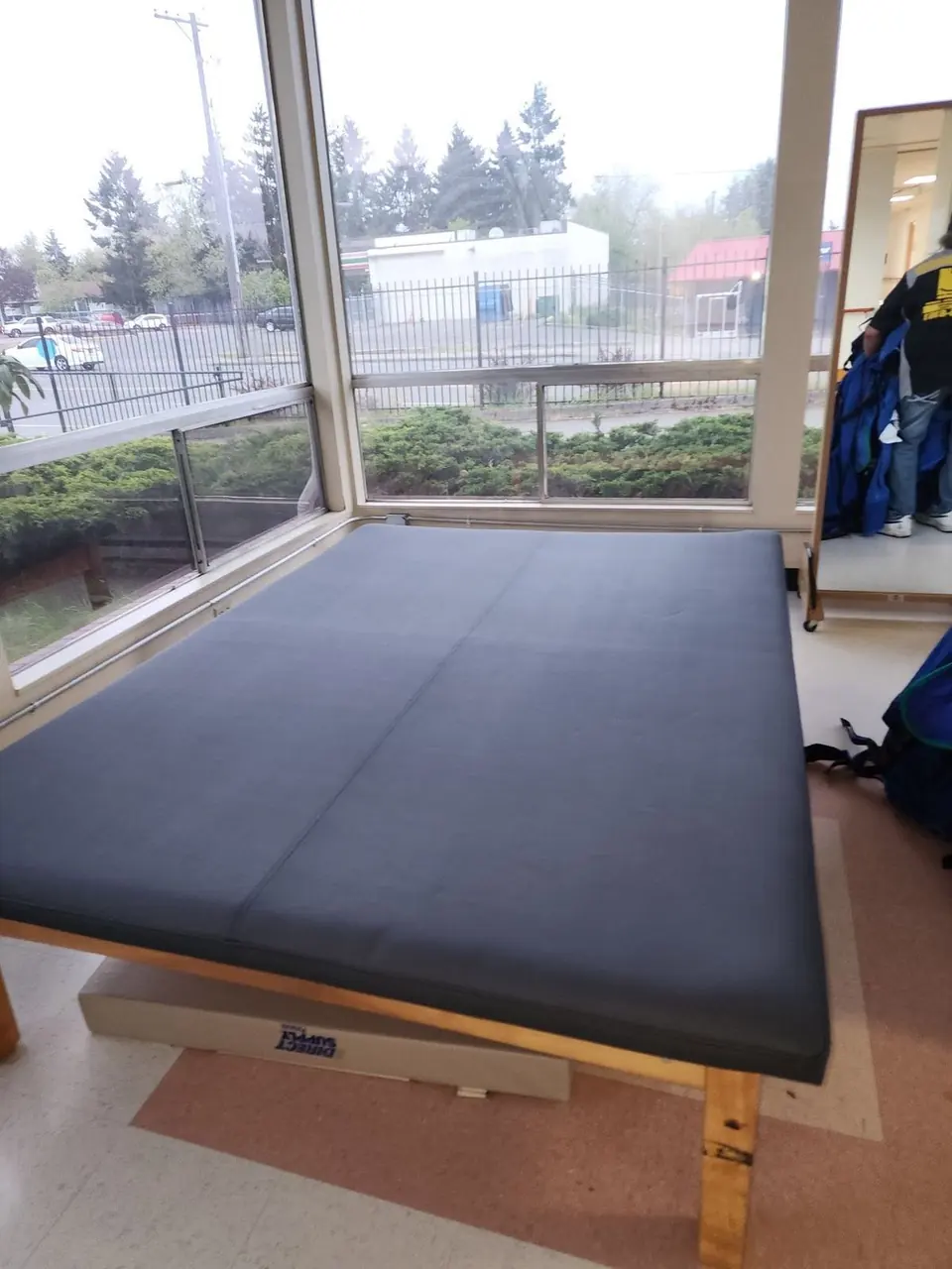 Physical therapy treatment table reupholstered in navy vinyl, installed in a clinic.