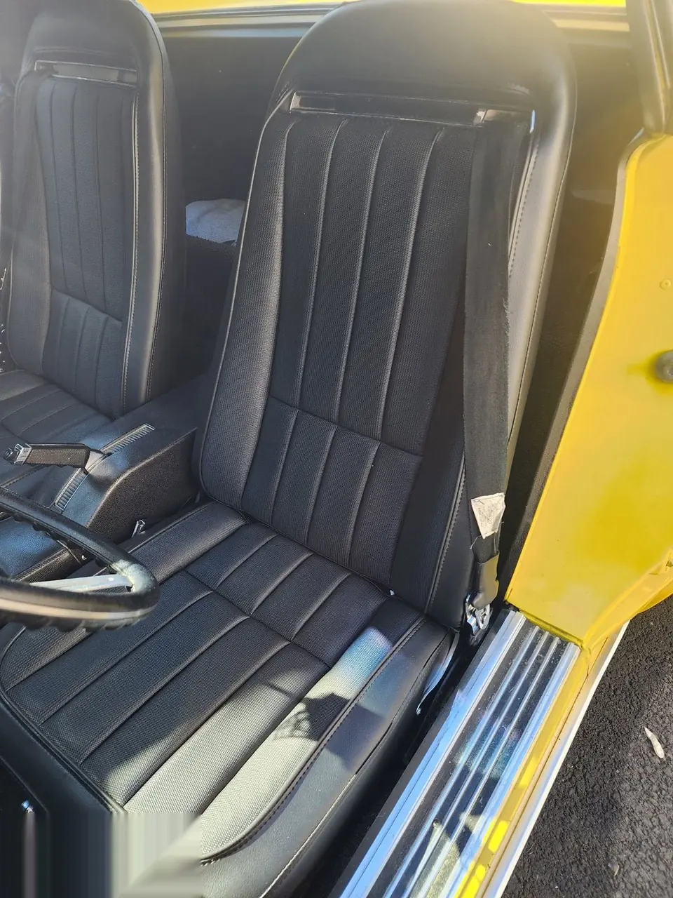 Quilted black vinyl seat installed in a classic Corvette.