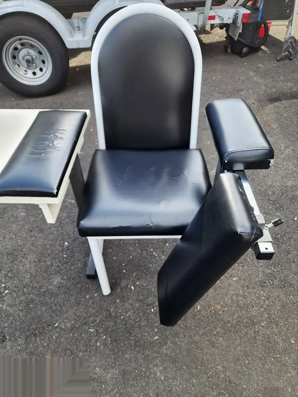 Black and white salon or spa chair before restoration.