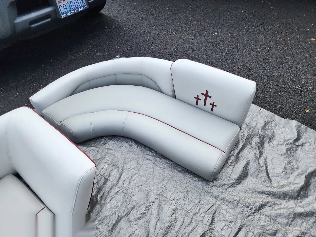 Close view of curved marine bench seating in white and red vinyl.