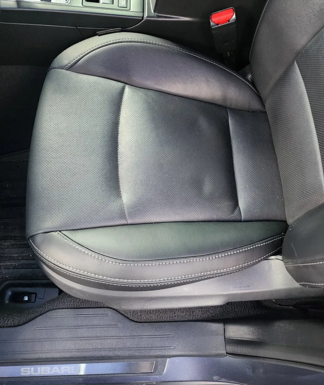 Subaru front seat reupholstered in black leather, installed in the vehicle.