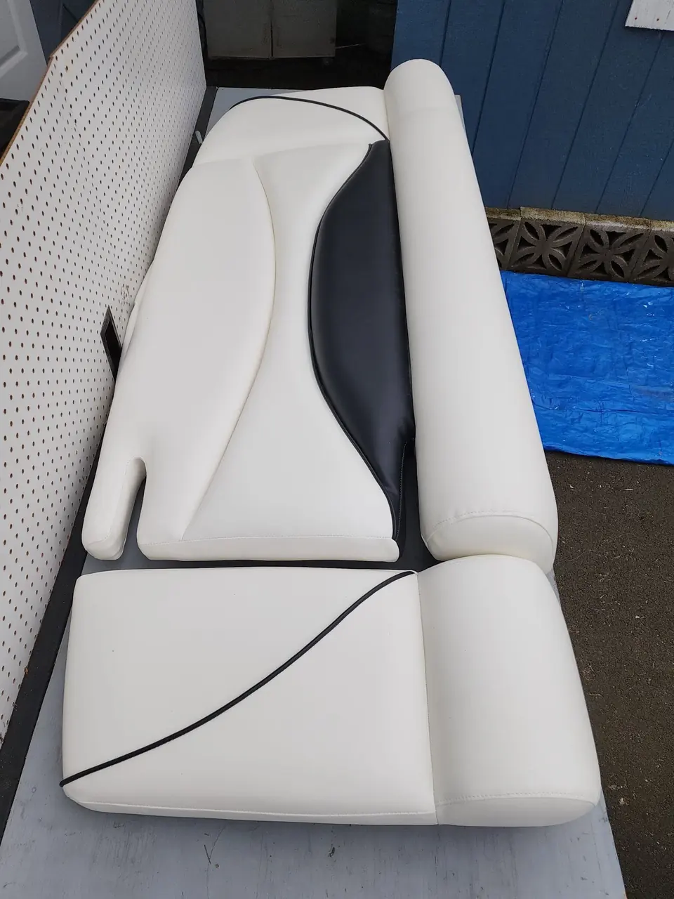 Boat seat back cushion reupholstered in white marine vinyl with black accent panel.
